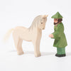 Wooden toy figure of hunter in green with white horse from Ostheimer | ©Conscious Craft